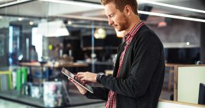 Man using tablet computer in warehouse